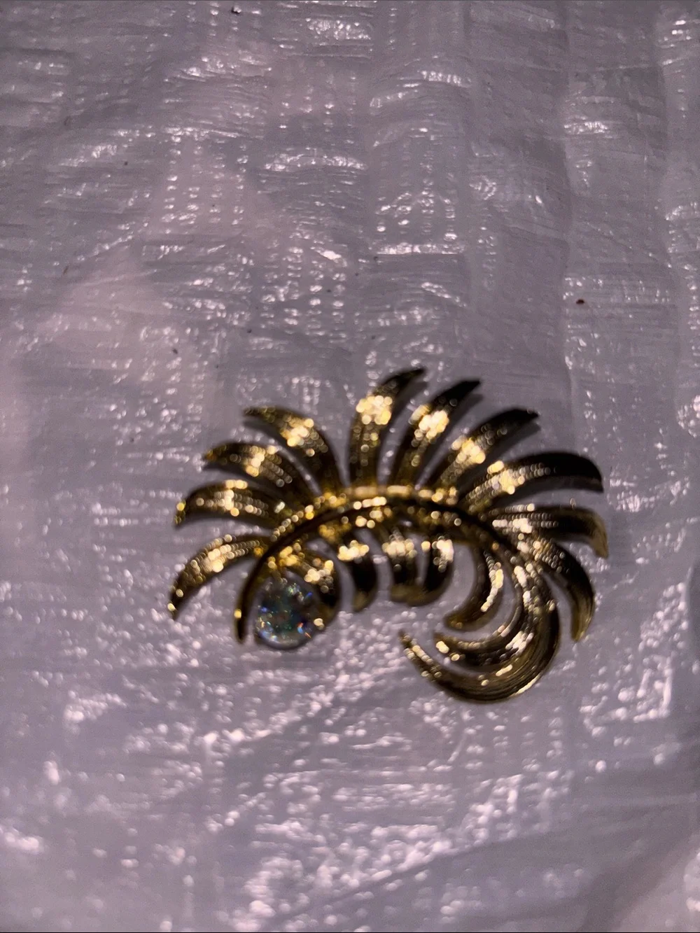 Gold Tone Floral Swirl Brooch with Iridescent Crystal